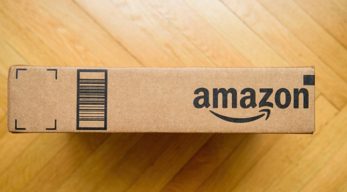 Amazon Business Featured Offer vs. Buy Box Strategies Amazon prime cardboard carton package on the wooden floor