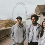 Three friends strolling in London wearing UK streetwear