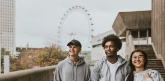 Three friends strolling in London wearing UK streetwear