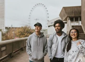 Three friends strolling in London wearing UK streetwear