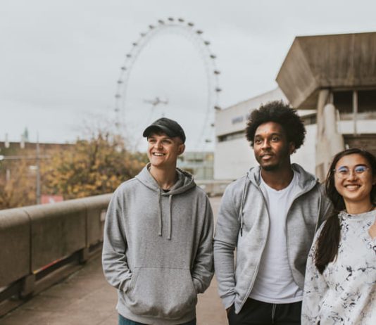 Why the Best Streetwear in the UK are Built on Community, Not Advertising Three friends strolling in London wearing UK streetwear