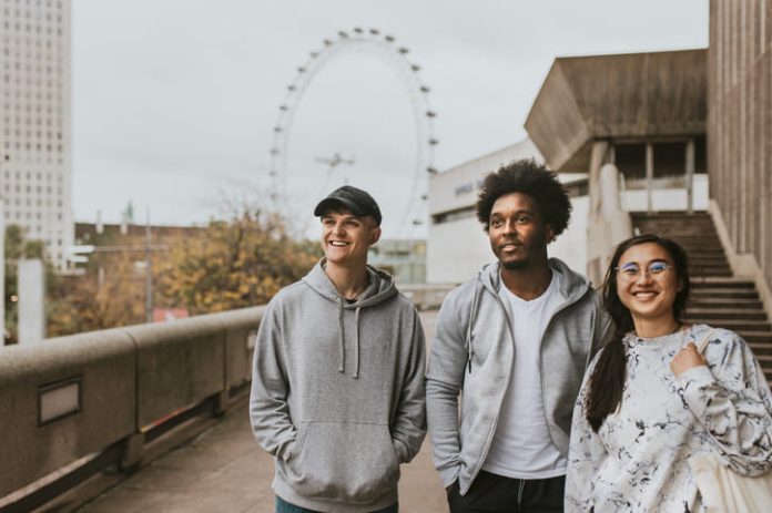 iStock-2157255547 (1) Three friends strolling in London wearing UK streetwear
