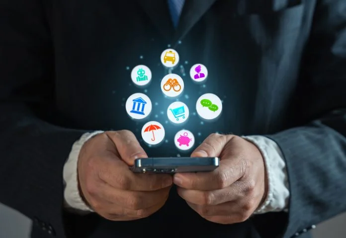 Businessman with a phone and a cloud of various services and mobile applications. Online business promotion and new experience for new customers users. An application that saves time and money. enterprise SuperApps