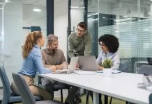 employees discussing payroll integration during a meeting