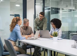 employees discussing payroll integration during a meeting