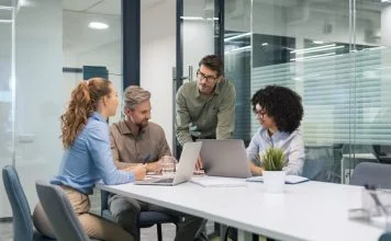employees discussing payroll integration during a meeting