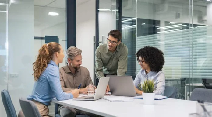 5 Ways Payroll Integration Helps Businesses Scale Smarter employees discussing payroll integration during a meeting