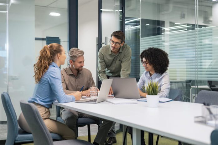 employees discussing payroll integration during a meeting
