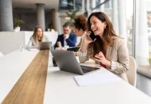 What Marketing Channels are Driving Your Phone Calls & How to Check marketing channel through phone calls. Woman talking over smart phone while sitting with laptop