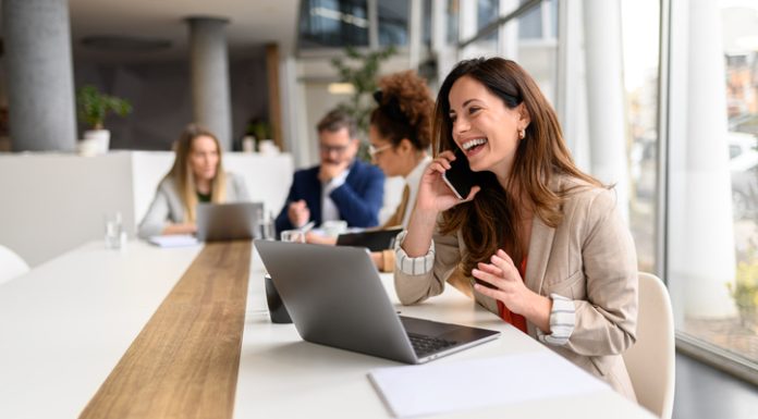 What Marketing Channels are Driving Your Phone Calls & How to Check marketing channel through phone calls. Woman talking over smart phone while sitting with laptop