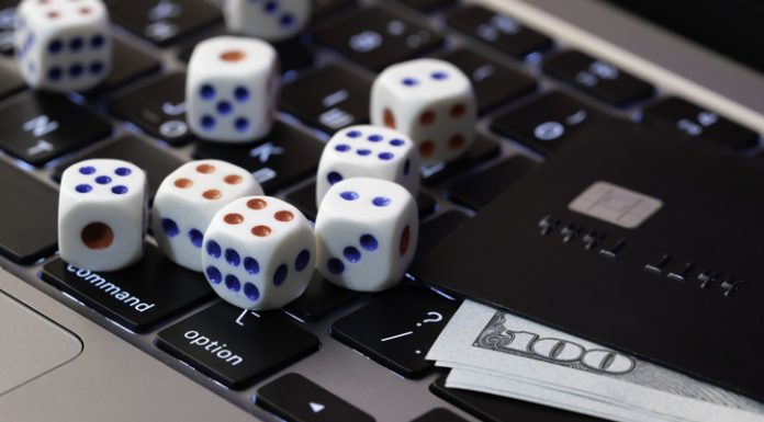 Instant Withdrawal Casinos: The Top 5 Fast-Paying Sites I Tested in 2026 Laptop keyboard with dice, credit card and cash, concept of online gambling, betting and casino games in digital world