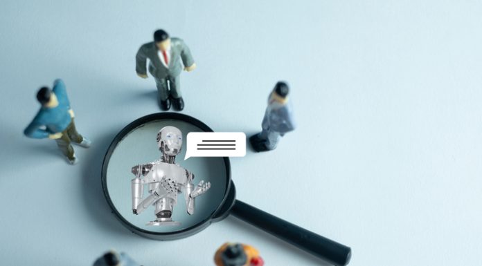 The Rearchitected Firm: Moving Beyond Hierarchies in an Age of Agentic AI The interaction between humans and AI. Miniature figures represent a team or customers engaging with a robot virtual assistant, symbolizing the future of communication and technology.