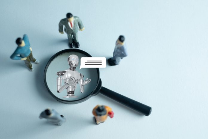The interaction between humans and AI. Miniature figures represent a team or customers engaging with a robot virtual assistant, symbolizing the future of communication and technology.
