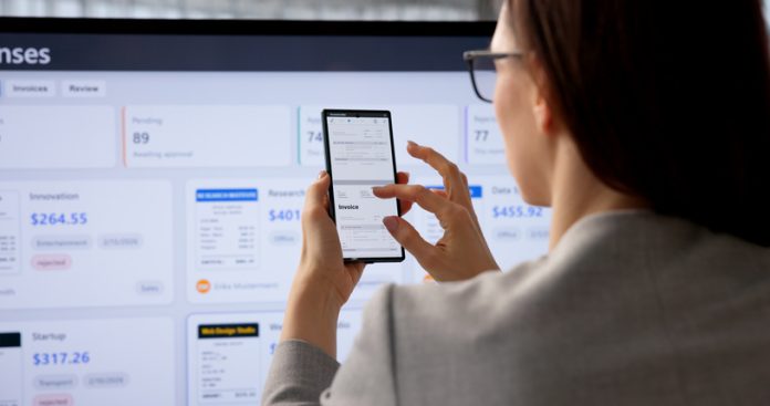 Businesswoman Managing Client Payments And Reviewing Digital Invoice factoring software