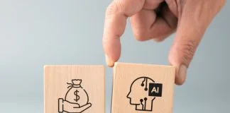 Hand placing an AI block next to a money symbol, representing AI adoption, income generation, business opportunities, productivity improvement, and technology driven growth