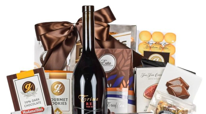 Why Corporate Gifting Is a Smart Business Investment Corporate gift basket with red wine, gourmet chocolates, brie cheese, and mixed nuts in a wooden crate