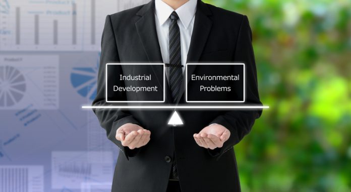 Business man thinkng about balance between industrial development and environment problems business agility
