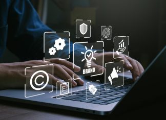 Man using laptop for brand marketing and management, branding concept.