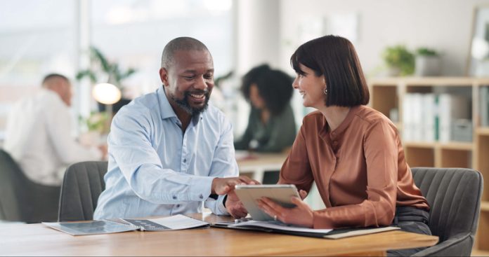 Business, people and banker with client on tablet at office for financial support and loan advice. Employee, customer and smile on internet for mortgage options with investment, help or consultation customer communication