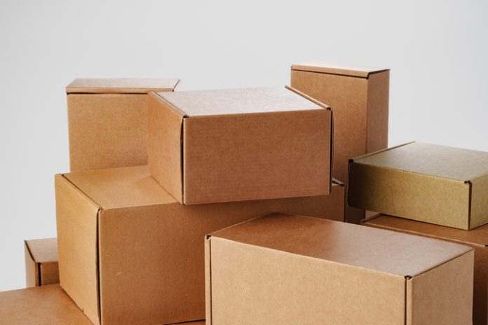 Stacked brown cardboard boxes in various sizes arranged on a white background Custom Box Sizes