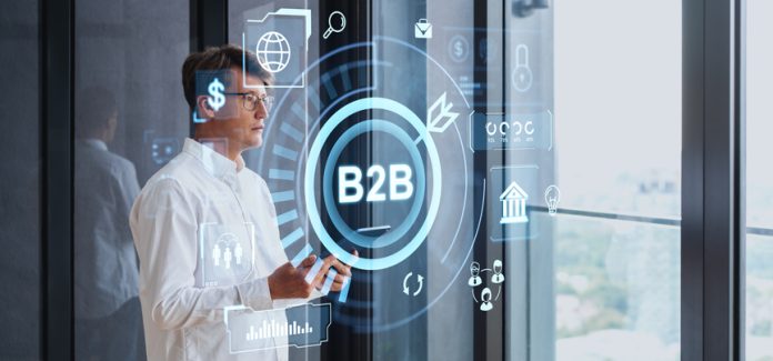 Businessman with tablet, b2b icons hologram and indicators fractional marketing leadership