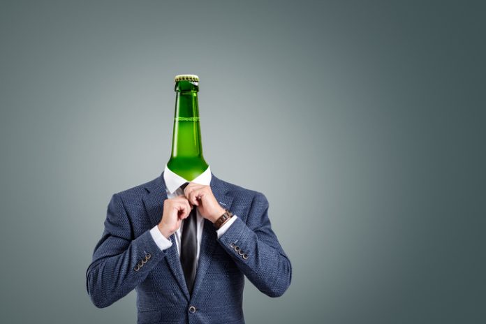 Surreal concept of a businessman with a bottle head A surreal composition depicting a businessman with a green bottle as his head.
