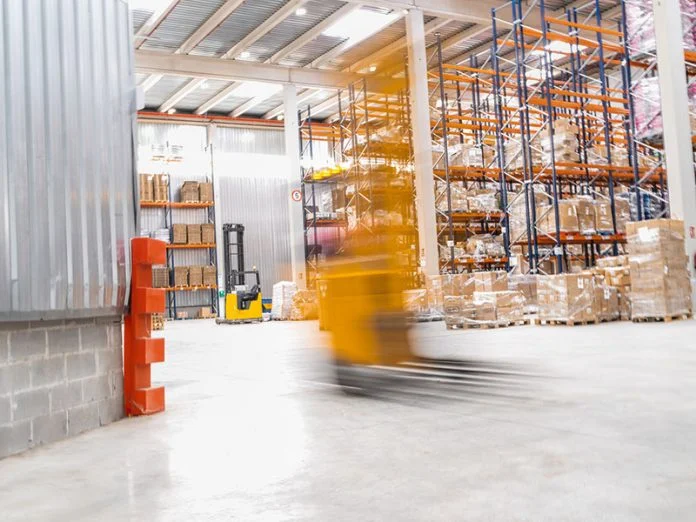 Forklift moving fast in a logistics warehouse Supply Chain 6.0
