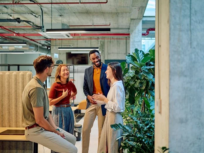Business team discussing new project in modern office with plants diverse leadership