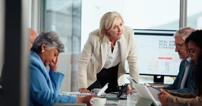 Boardroom, manager and talking to employees, angry and discussion for failed deal or accountability. Upset, woman and people with guilt for missed deadline, poor performance and risk of job loss difficult bosses in the workplace