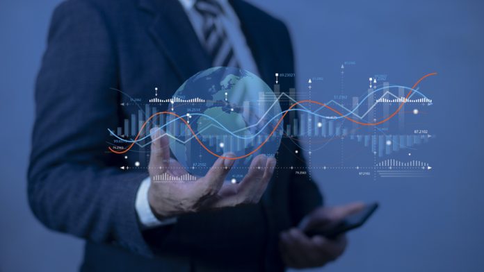 Businessman holding planet Earth with glowing chart. Graph stock market with rising candlesticks. Infographic elements and realistic transparent world map. citizenship by investment