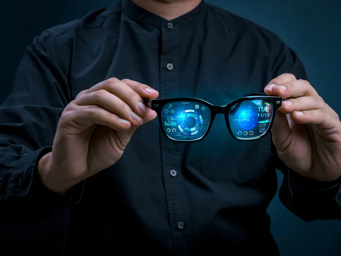 Smart glasses with augmented reality interface displaying digital data and futuristic UI dashboard in businessman hands. Wearable technology, real-time analytics, next-generation digital experience. AI Glasses, Wearable technology, real-time analytics, next-generation digital experience.