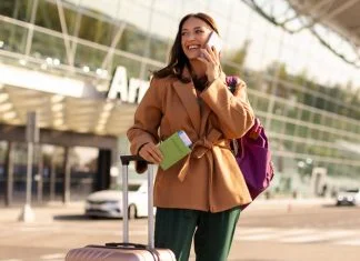 Connectivity is Becoming the New Currency of Travel Loyalty woman talking on the phone after arrival while traveling, reward from Travel Loyalty