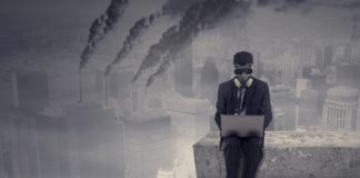 Male worker working on the rooftop while using laptop computer and wear a gas mask with air pollution in the city, Companies operating despite the negative impact on society concept.