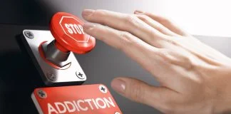 Why Addiction Recovery is Becoming Big Business in the Tech Space Woman pressing a panic button with stop sign to overcome addiction or dependence problems.