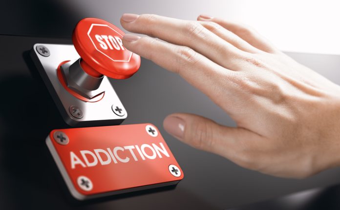 Psychology concept, Stop Addiction or Dependence Woman pressing a panic button with stop sign to overcome addiction or dependence problems.