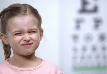 Why are Thousands of Neurodivergent British Children Missing Out on Basic Sight Tests? Neurodivergent British Children - Small girl frowning