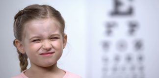 Why are Thousands of Neurodivergent British Children Missing Out on Basic Sight Tests? Neurodivergent British Children - Small girl frowning