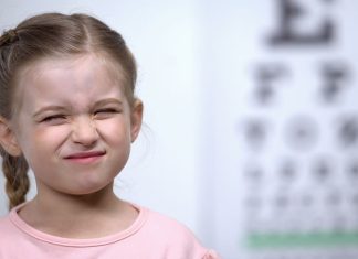 Why are Thousands of Neurodivergent British Children Missing Out on Basic Sight Tests? Neurodivergent British Children - Small girl frowning