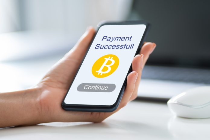 Businessperson Videochatting With Doctor On Smartphone Bitcoin Payment