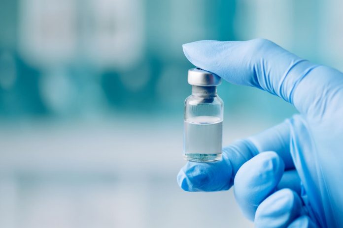 iStock-1446086131 (1) Peptide Receptor Binding - holding glass vial
