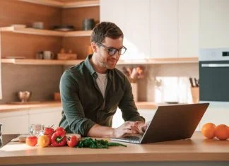 Why Cooking and Nutrition are Underrated Leadership Tools Businessman cooking in the kitchen while working. Cooking and nutrition leadership concept