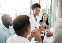 The Best Fixed-Fee Recruitment Partners for Funded Startups in 2026 Recruitment partners concept. Diversity, human resources and black woman doctor shaking hands in welcome or thank you.