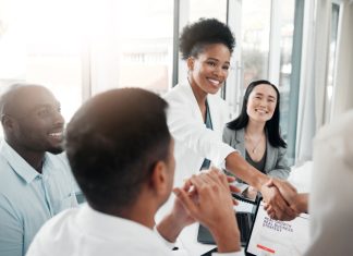 Recruitment partners concept. Diversity, human resources and black woman doctor shaking hands in welcome or thank you.