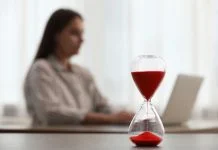 Woman using laptop indoors, selective focus for time management