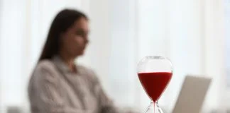 Woman using laptop indoors, selective focus for time management