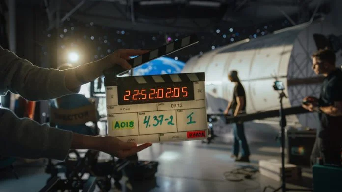 Director Filming Ad Shoot With Astronaut Fixing Satellite. Actor Floats on Rope Against Digital Earth Backdrop. Behind-the-scenes of Commercial Production. filmmaking