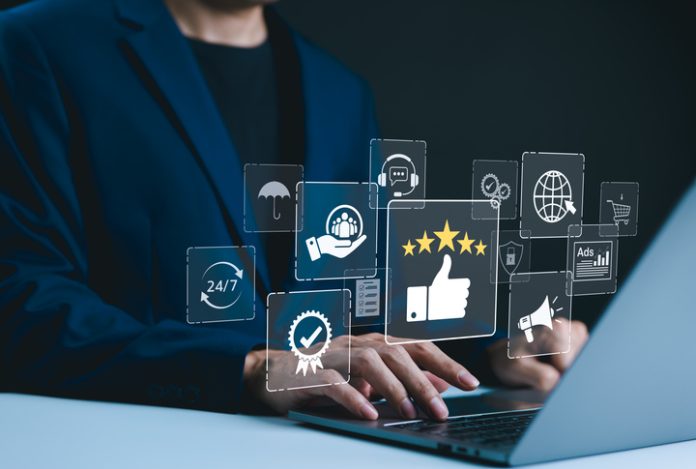 Service Excellence and Quality Assurance. Businessman types on a laptop with icons representing service excellence, including a thumbs-up, five stars, and various customer service elements. CRM Reputation Management Agency in the AI Era