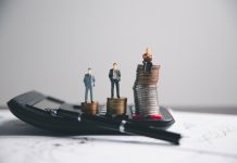 How Businesses Can Build a Stronger Presence in Competitive Markets Financial calculate accountant blur background close up on calculator with graph chart banner bank office desk. Finance Concept tax banking money expense accounting budget, market presence, businessman use calculator.