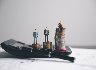 Financial calculate accountant blur background close up on calculator with graph chart banner bank office desk. Finance Concept tax banking money expense accounting budget, market presence, businessman use calculator.