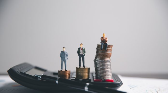 Financial calculate accountant blur background close up on calculator with graph chart banner bank office desk. Finance Concept tax banking money expense accounting budget, market presence, businessman use calculator.